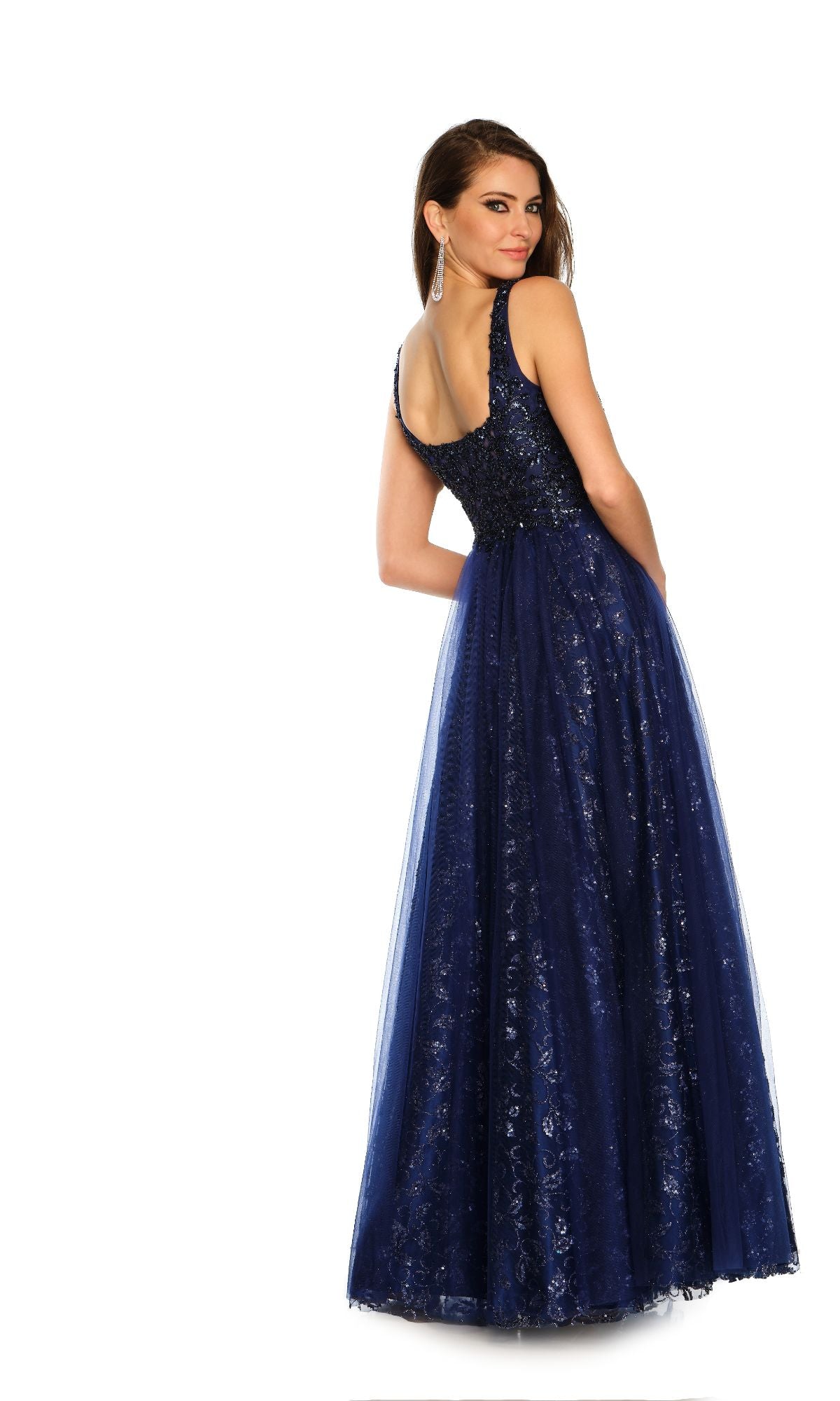 Woman wearing the Dave and Johnny Navy Long Glitter Prom Dress 11008, a sleeveless A-line gown with glitter details, posing with one hand behind her back against a white background.